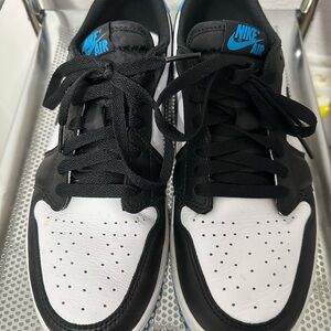Nike Women's Dunk Low Black and White Sneakers with Blue accents.